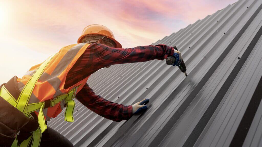 man working on metal roof