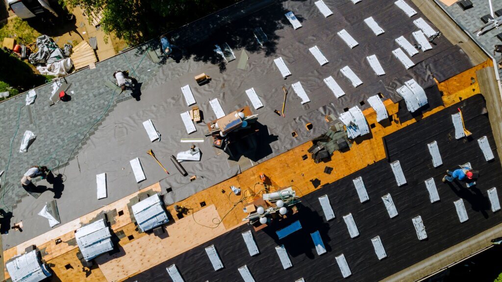 a sky view of a commercial building getting a new roof