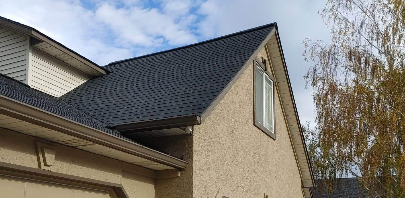 New drip edge, straight ridge line asphalt roof with clean fascia alignment over garage was freshly installed.