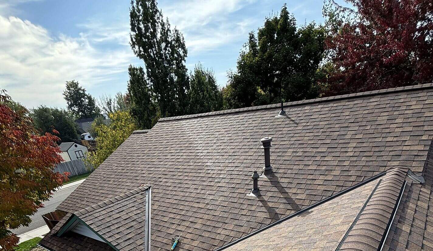 Multi-plane roof with exact flashing around all pipe penetrations, integrated ridge vent, and new asphalt shingles.