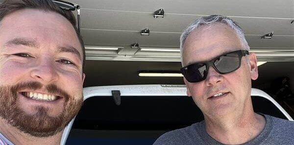 Following a successful roofing job in Meridian, Idaho, a contractor and homeowner are grinning and giving the thumbs up.