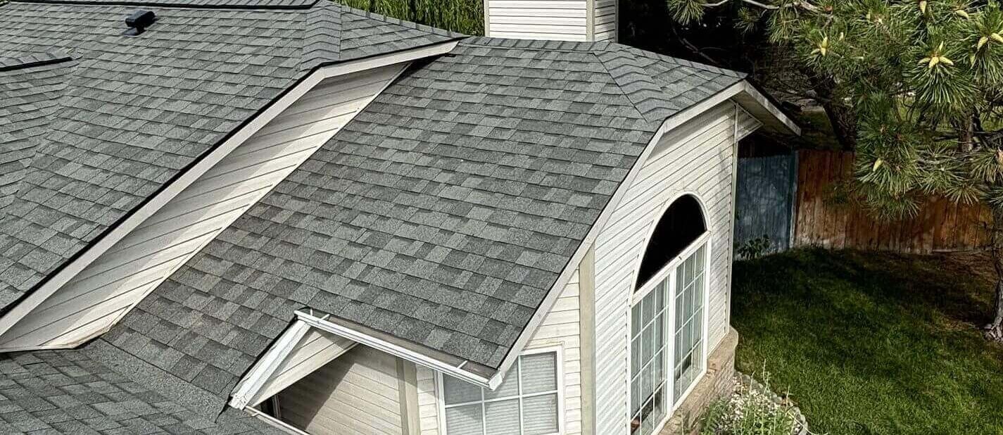 Clean valleys and a well-vented chimney structure are features of the multi-plane asphalt shingle roof.