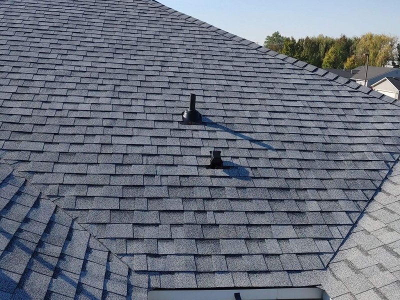Roof replacement project featuring gray architectural shingles across multiple roof faces in Nampa.